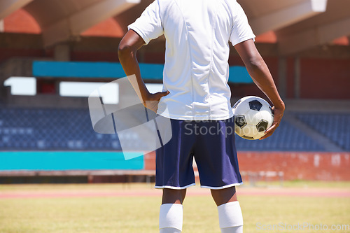 Image of Man, holding soccer ball and back in stadium for game, competition or outdoor for sports career. Football player, ready and motivation for sport, workout and exercise for health, wellness and contest