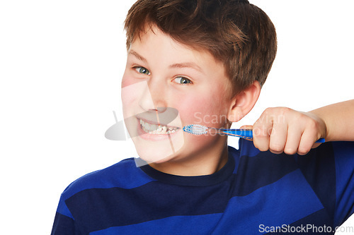 Image of Portrait, smile and kid brushing teeth in studio isolated on a white background. Face, boy and child with tooth brush for oral health, hygiene and dental wellness, fresh breath and cleaning gums.