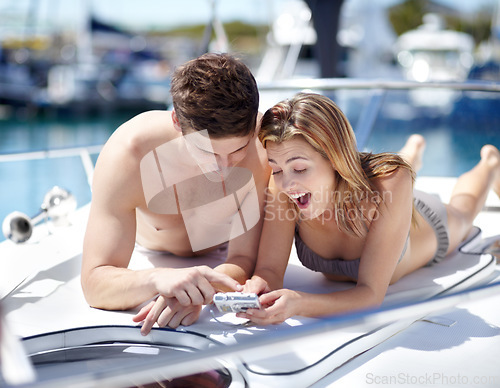 Image of Young couple relax on yacht for summer vacation, holiday or travel excited for picture, digital memory and love. Happy gen z woman, partner or people on cruise boat for valentines celebration or date