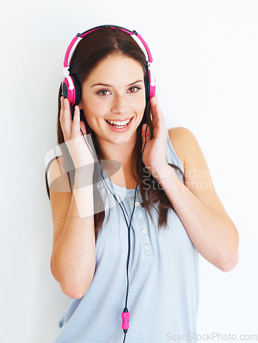 Image of Music headphones, portrait and happy woman listening to fun girl song, wellness audio podcast or radio sound. Studio smile, freedom and gen z model streaming edm playlist isolated on white background