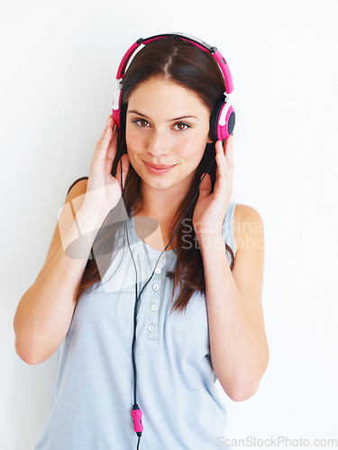 Image of Music headphones, portrait and woman listening to fun girl song, wellness audio podcast or radio sound. Studio smile, happy freedom and gen z model streaming edm playlist isolated on white background