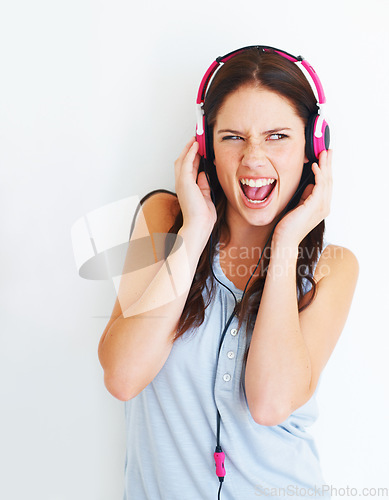 Image of Music headphones, singer and woman listening to fun girl song, wellness audio podcast or radio sound. Crazy studio singer, excited energy and singing model streaming edm isolated on white background