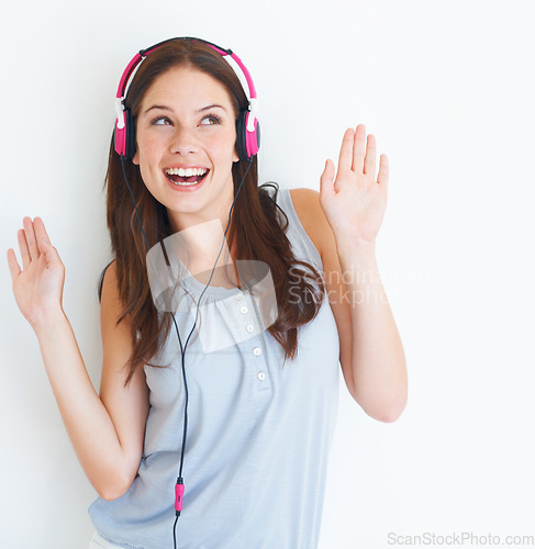 Image of Music headphones, dance and happy woman listening to fun dancing song, wellness audio podcast or radio sound. Studio dancer, excited energy girl and model streaming edm isolated on white background