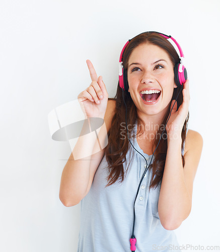 Image of Music headphones, pointing and happy woman listening to girl song, audio podcast or radio sound. Mockup gesture, studio freedom and excited model streaming edm playlist isolated on white background