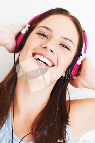 Image of Music headphones, happy face and woman portrait listening to fun girl song, wellness audio podcast or radio sound. Studio smile, freedom and model streaming edm playlist isolated on white background