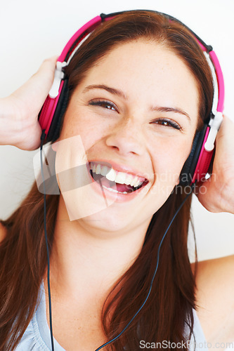 Image of Music headphones, face and woman portrait listening to fun girl song, wellness audio podcast or radio sound. Studio smile, freedom and happy model streaming edm playlist isolated on white background