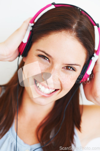 Image of Music headphones, face and woman portrait listen to fun girl song, wellness audio podcast or radio sound. Studio smile, freedom and happy model streaming edm playlist isolated on white background