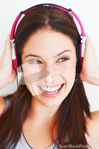 Image of Music headphones, studio face and happy woman listening to fun girl song, wellness audio podcast or radio sound. Smile, freedom and gen z model streaming edm playlist isolated on white background