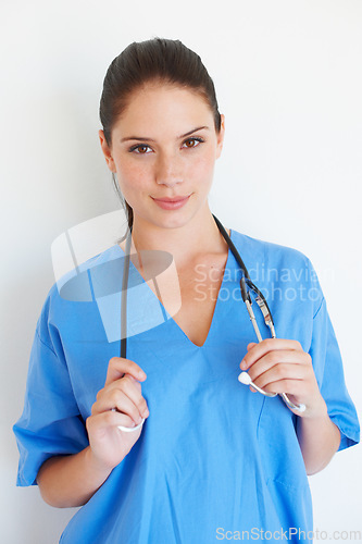 Image of Studio portrait, stethoscope and nurse smile for nursing career, wellness service or cardiology healthcare support. Medicine doctor, caregiver woman or hospital surgeon isolated on white background