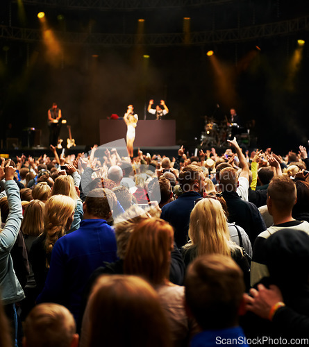 Image of Dance, music and stage with crowd at festival for concert, dj show and rave performance. Rock, energy and hands of people dancing in audience for party celebration, disco and techno event