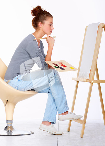 Image of Woman, painting and thinking about art canvas in studio for creativity and talent with paint brush for color. Female artist or painter isolated on a white background for creative work and ideas