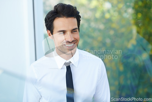 Image of Thinking, corporate and smile with a business man in the modern office of his company at work. Idea, window or mockup with a handsome, young and happy male employee in his professional workplace