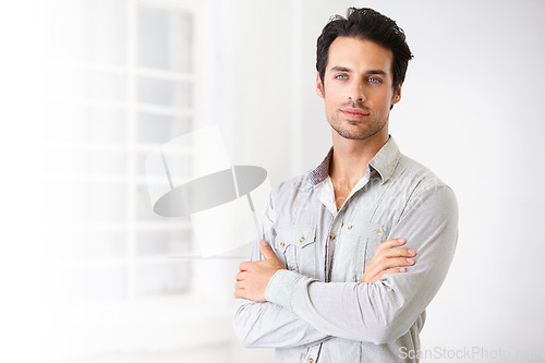 Image of Portrait, man and real estate agent with arms crossed, pride for career or job with mockup. Face, serious and male realtor, entrepreneur and confident professional from Spain standing in home.