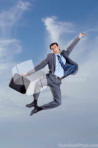 Image of Business man, heel click and sky with suit, happiness and freedom for success, goal or outdoor for celebration. Young entrepreneur, businessman and dancer with excited jump, comic portrait and clouds