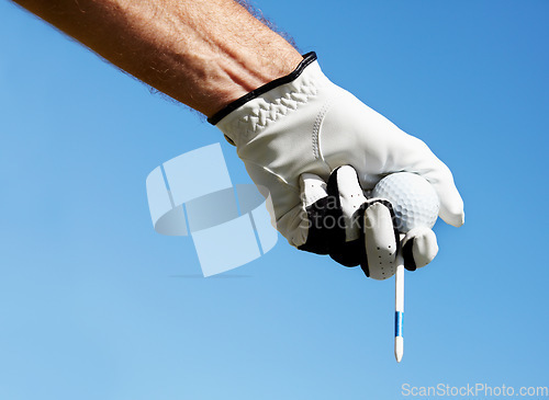 Image of Golf ball, tee and hands of man on blue sky for contest, competition challenge and summer training on mockup. Closeup, gloves and golfer holding pin for action, games and outdoor gear for sports