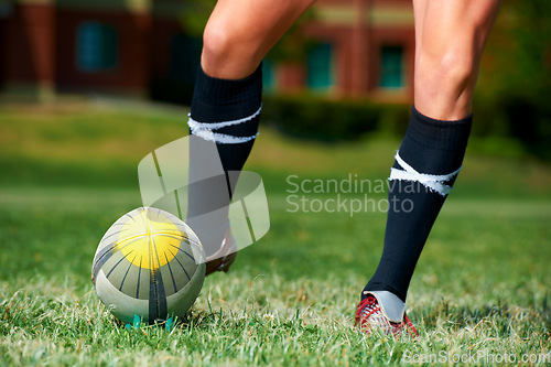 Image of Rugby, feet and man with a sports ball outdoor on a pitch for action, goal or score. Male athlete person playing in sport competition, game or start training for fitness, workout or kick exercise