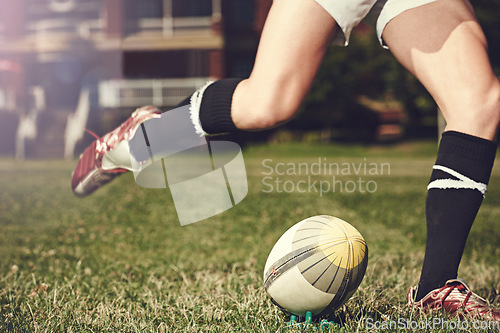 Image of Rugby, man and feet kick sports ball outdoor on a pitch for action, goal or score. Male athlete person playing in sport competition, game or start training for fitness, workout or exercise on grass