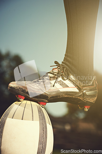 Image of Rugby man, feet and sports ball outdoor on a pitch for action, goal or score. Male athlete closeup of shoes playing in sport competition, game or start training for fitness, workout or exercise