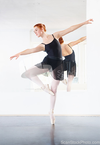 Image of Ballerina, ballet and woman is dancing in class, young dancer in rehearsal with art and grace at studio. Female person in pointe pose, balance and training for performance with creativity and fitness