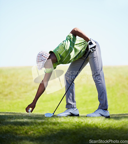 Image of Sports, golfer and black man with golf ball on lawn for game, match and competition on golfing course. Recreation, hobby and male athlete with club driver on grass for training, fitness and practice