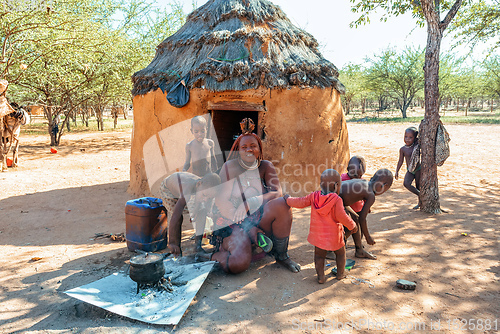 Image of Himba woman with child in the village