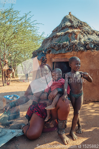 Image of Himba woman with child in the village