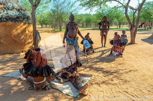 Image of Himba woman with child in the village