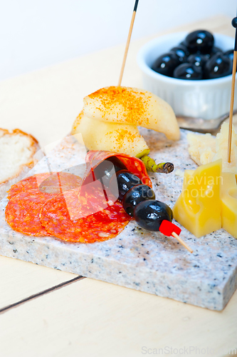 Image of mix cold cut on a stone with fresh pears