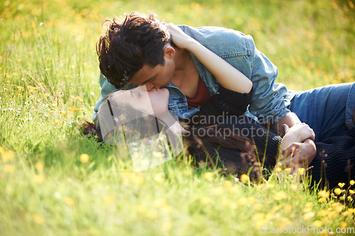 Image of Love, kiss and peace with couple in grass of field for summer, date and valentines day bonding. Affectionate, romance and nature with man and woman lying in garden meadow for spring, relax and happy