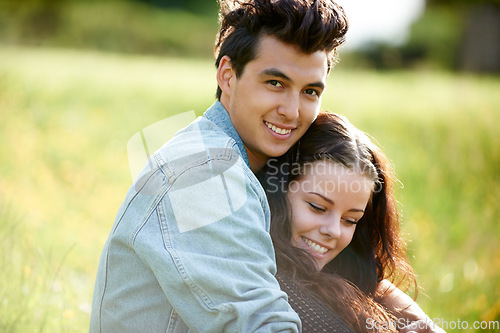 Image of Field, love and couple relax in nature for romance, summer or valentines celebration with portrait, smile and sunshine. Young people or woman and partner on picnic, grass or countryside date together