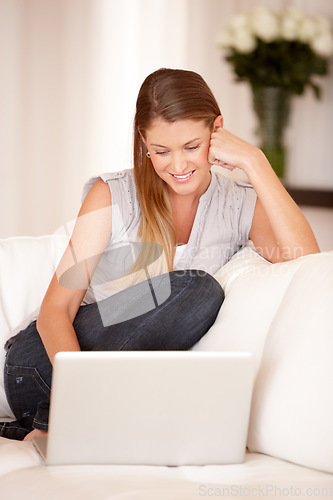 Image of Relax, laptop and happy with woman on sofa in living room for social media, streaming and website. Search, technology and digital with female user typing at home for connection, email and internet