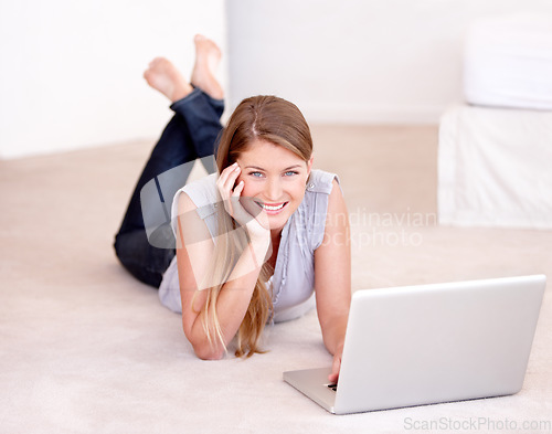 Image of Laptop, relax and portrait of a woman on the floor browsing on social media, website blog or the internet. Happy, smile and female person laying on the ground with computer for entertainment at home.