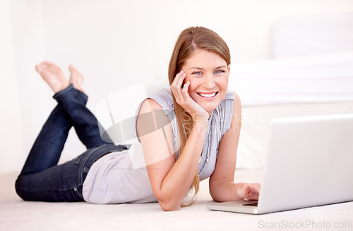 Image of Laptop, online and portrait of a happy woman on the floor browsing on social media, website blog or the internet. Relax, smile and female person on the ground with computer for entertainment at home.