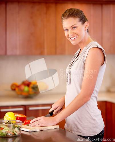 Image of Woman, portrait and knife for cutting pepper with smile, vegetables or nutrition in home kitchen for health. Girl, happy chef and vegetable for food, wellness and diet in apartment with healthy lunch