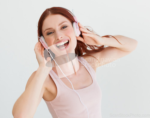 Image of Woman, headphones and studio portrait with smile for music, streaming subscription or podcast by background. Isolated girl, student or model with happiness for audio, sound and internet radio by wall