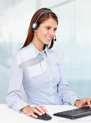 Image of Happy business woman, call center and computer for consulting, customer service or support at office. Friendly female consultant agent with smile for telemarketing or online advice on PC at workplace