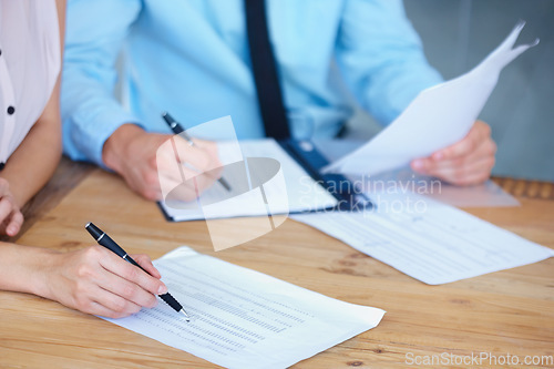 Image of Business people, hands and writing on financial documents in accounting or budget expenses on office desk. Auditor working on finance report in team collaboration or audit with spreadsheet on table