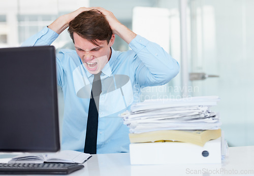 Image of Stress, shouting and burnout with a business man in his office, sitting at a desk while working on a problem. Audit, tax and anger with a young male employee suffering from deadline pressure at work