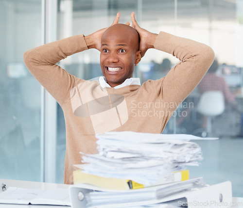 Image of Stress, documents and mistake with a business man in his office, sitting at a desk while working on a problem. Audit, tax and compliance with a black male employee suffering from burnout at work