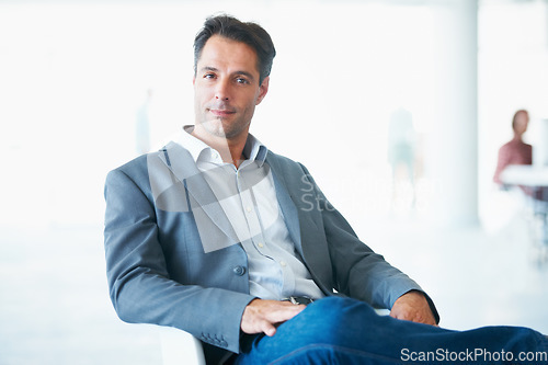 Image of Portrait, serious and business man on chair in office with pride for career, occupation or job. Professional, male entrepreneur and executive, mature ceo or person from Canada sitting in workplace.