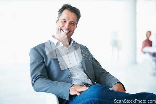 Image of Portrait, happy and business man on chair in office with pride for career or job. Professional, male entrepreneur and smile of executive, mature ceo or person from Canada sitting in company workplace