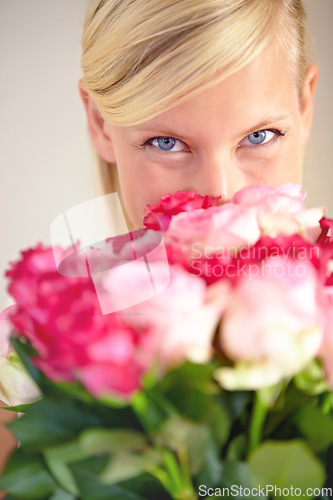 Image of Roses, bouquet and portrait of woman in studio for valentines day, gift or thank you gesture on grey background. Face, rose and girl with flowers, happy and relax with floral arrangement on mockup