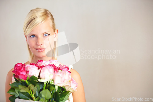 Image of Portrait, roses and woman in studio for valentines day, gift or thank you gesture on wall background. Face, rose and girl with flowers, plants and relax with floral arrangement and mockup space