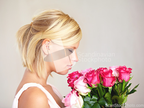 Image of Smelling, side profile and woman with flowers as a gift isolated on a white studio background. Aroma scent, romantic and girl with a bouquet of roses for valentines day or anniversary on a backdrop