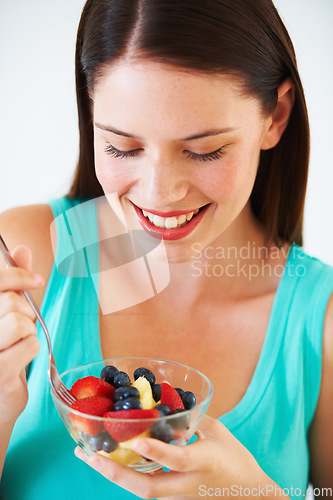 Image of Happy woman, food and eating a healthy fruit salad with berries, nutrition and health benefits. Face of a female person on nutritionist diet with vegan meal for weight loss, wellness or detox