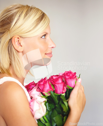 Image of Woman, rose and bouquet in studio for valentines day, gift or thank you gesture on white background. Fresh, roses and girl with flowers, happy and relax with floral arrangement and mock up space