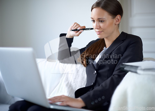 Image of Business woman, couch and laptop for thinking with mindset, smile or idea for vision in home office. Entrepreneur, freelancer and computer with focus, goal or remote work with pen, search or ideas