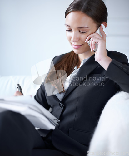 Image of Business woman, phone call and notebook on sofa for schedule management, communication and remote work. Entrepreneur, smile and listening with smartphone, book and writing on couch in home office