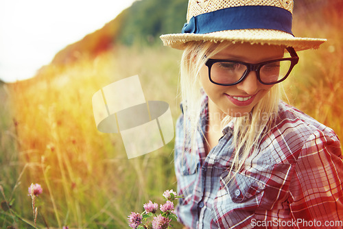 Image of Lens flare, summer and woman with flowers in field for freedom, wellness and fresh air outdoors. Nature, countryside and happy female person in natural meadow for relaxing, calm and peace in morning