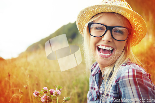 Image of Happy, countryside and face of woman laugh in field for freedom, wellness and fresh air outdoor. Nature, hipster and portrait of person in meadow with lens flare for relaxing and sustainability